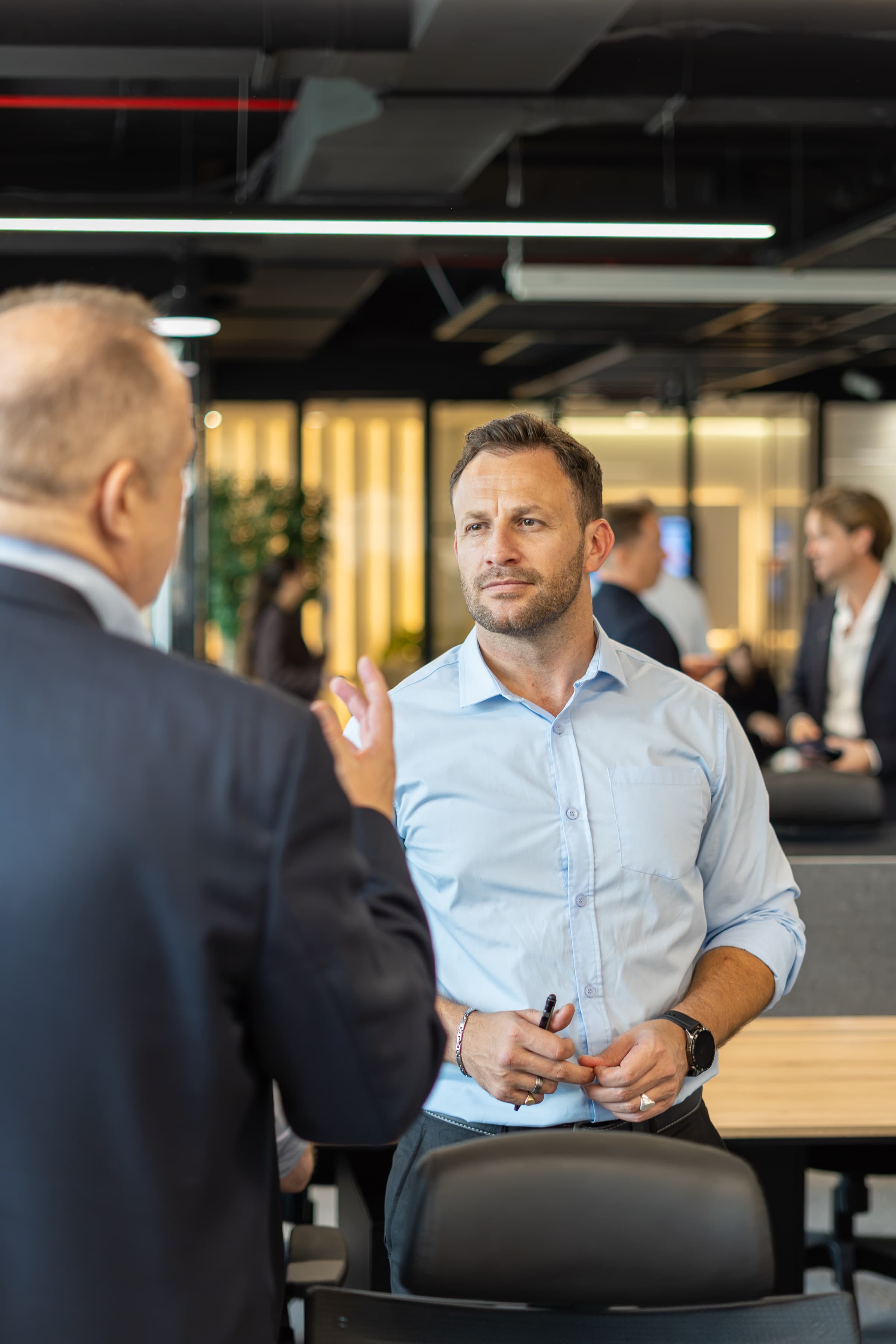 A McCone agent in conversation on the office floor