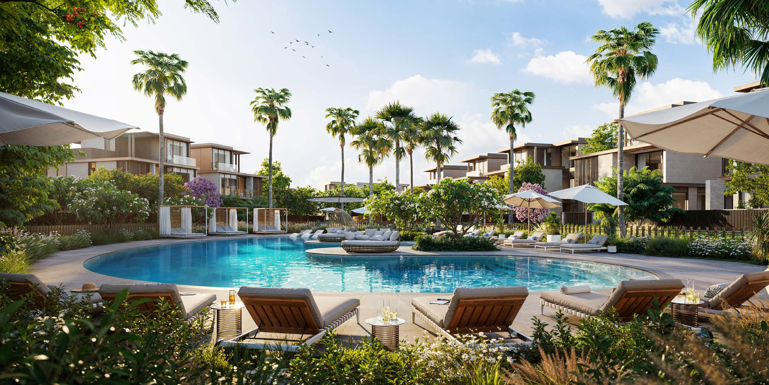 A community pool at Nad Al Sheba Gardens, among palms and villas