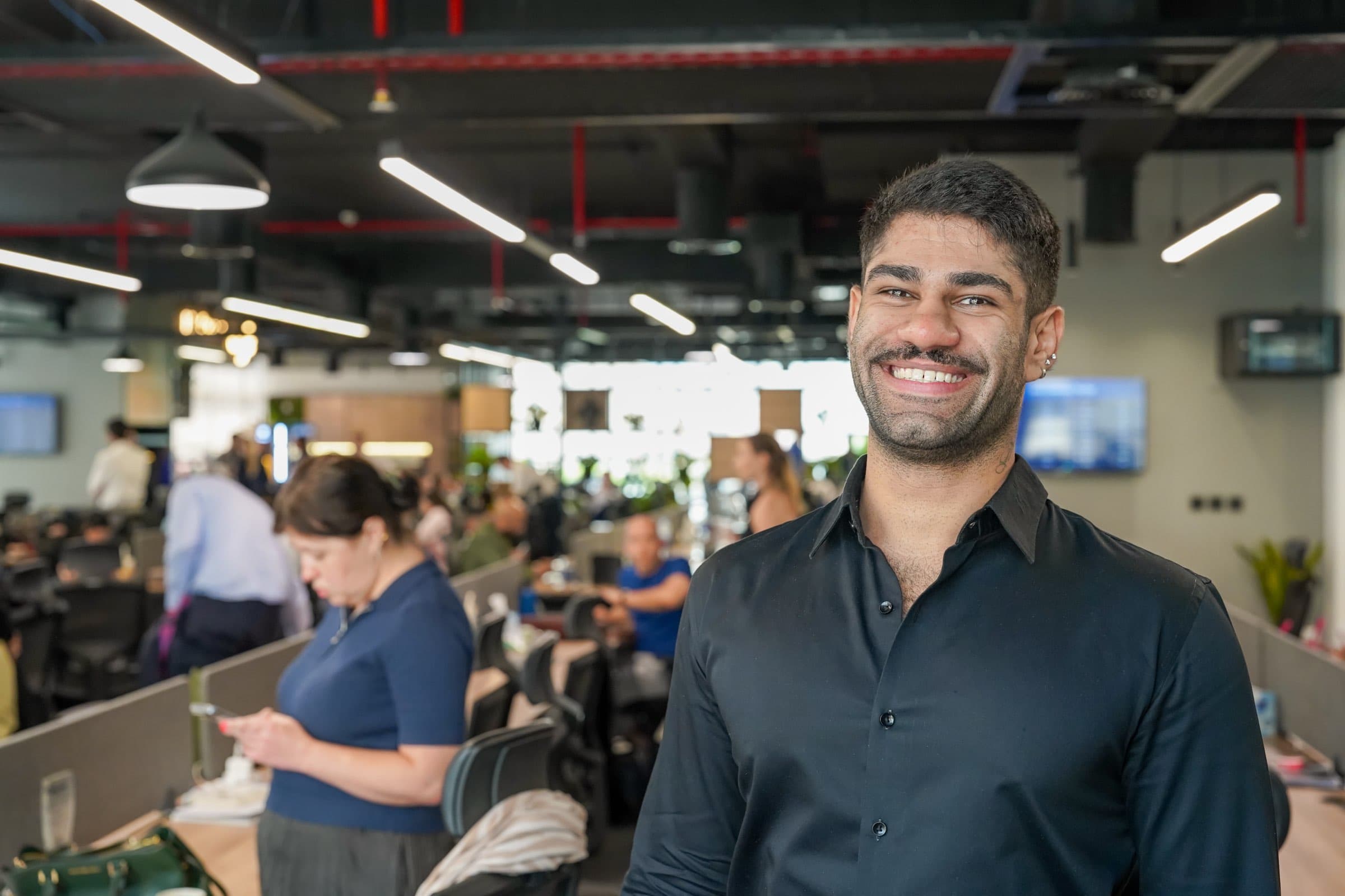A McCone leasing agent smiling on the office floor in Dubai