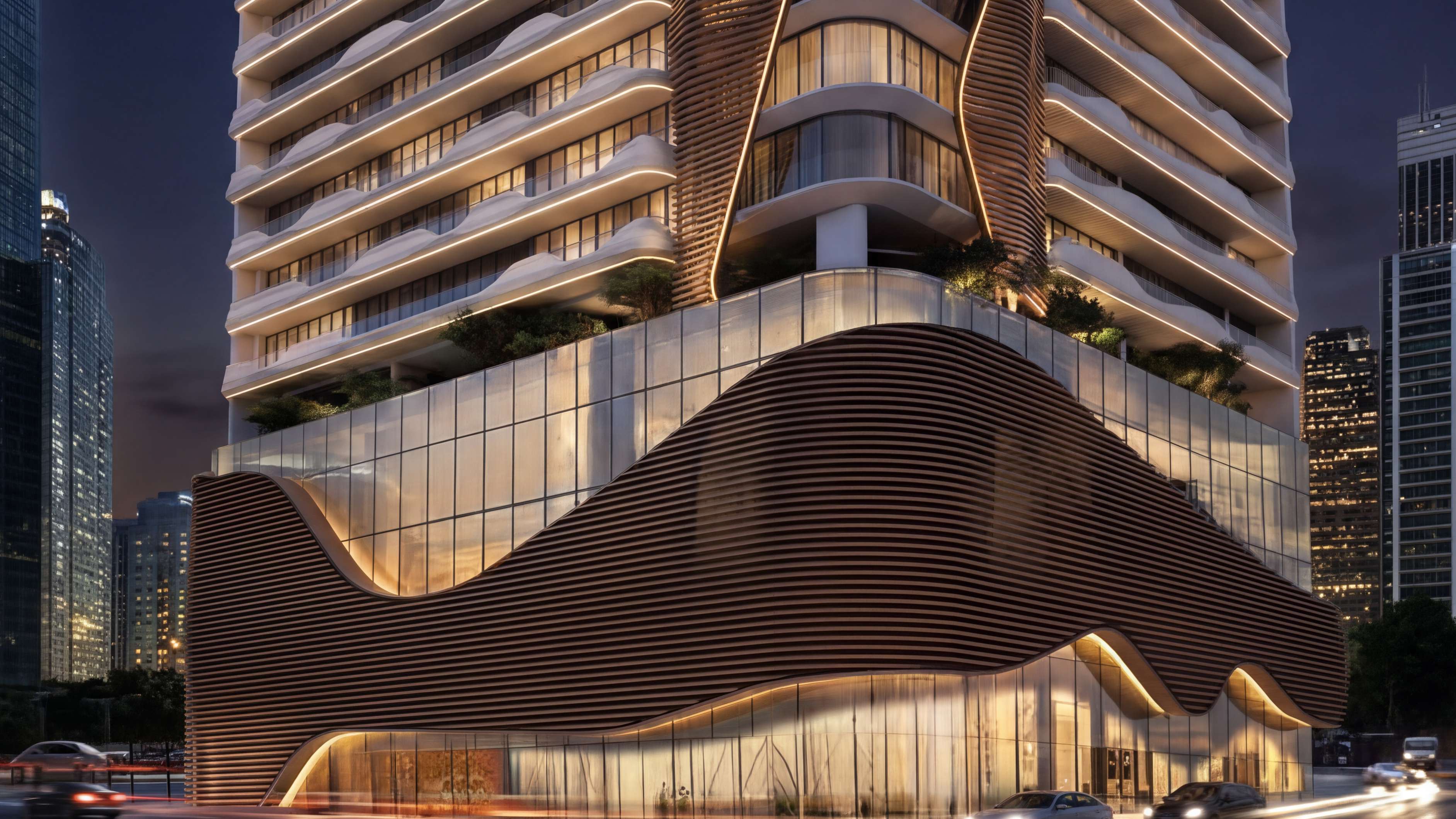 The tower's curving podium and glowing balconies lit up at night