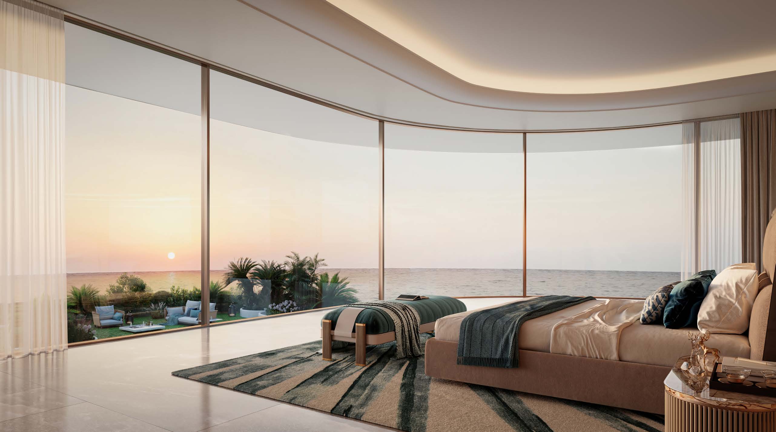 Master bedroom with curved floor-to-ceiling glass facing the sea at sunset