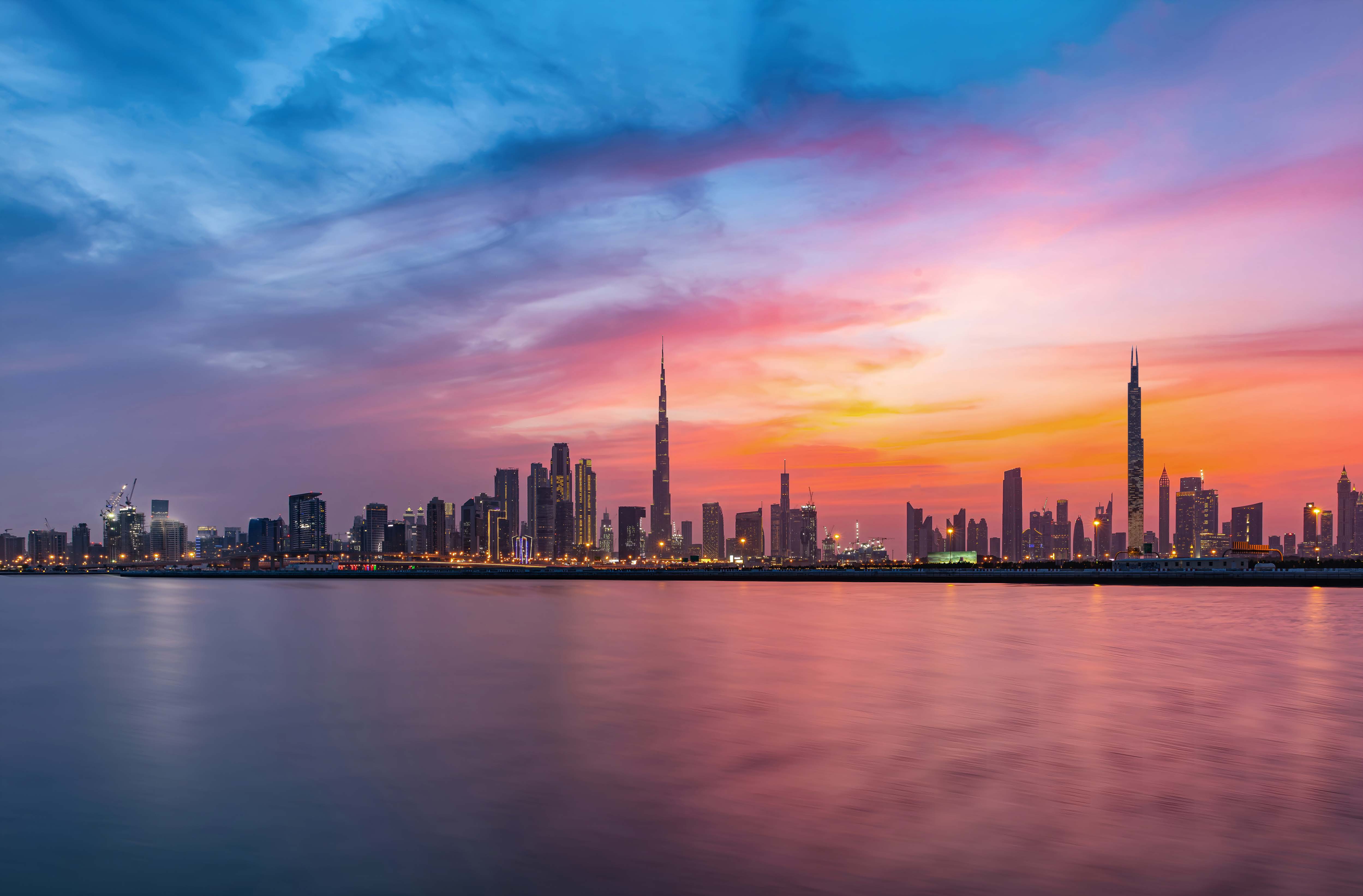 Burj Azizi rising above a sea of clouds, with Burj Khalifa in the distance