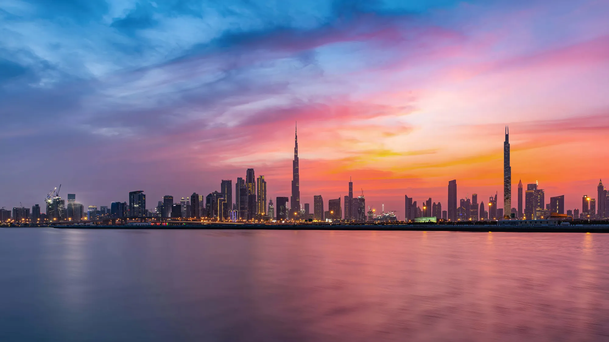 Burj Azizi rising above a sea of clouds, with Burj Khalifa in the distance