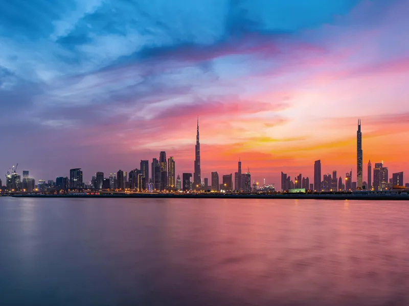 Burj Azizi rising above a sea of clouds, with Burj Khalifa in the distance