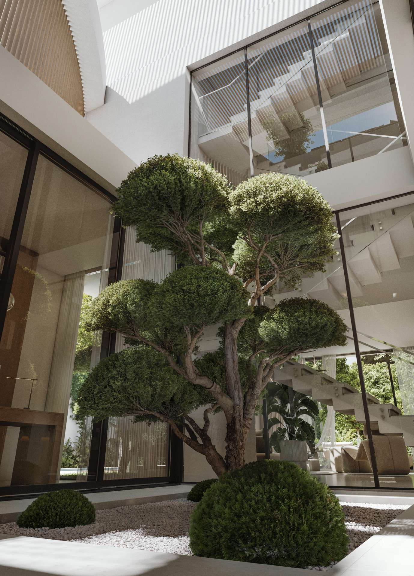 Inner courtyard with a sculpted tree under a triple-height glass atrium