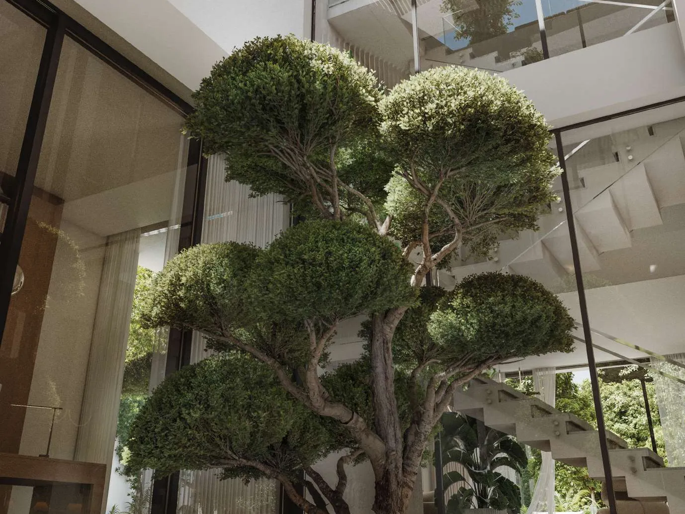 Inner courtyard with a sculpted tree under a triple-height glass atrium