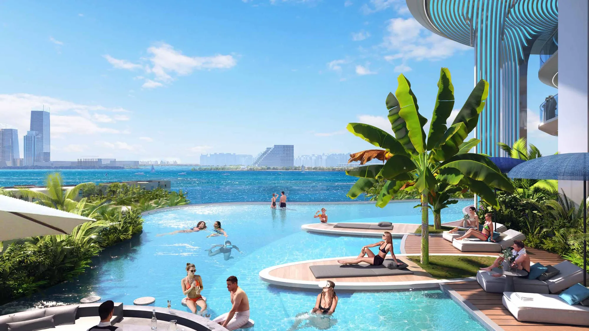 Infinity pool with sun loungers and palms, the sea and skyline beyond