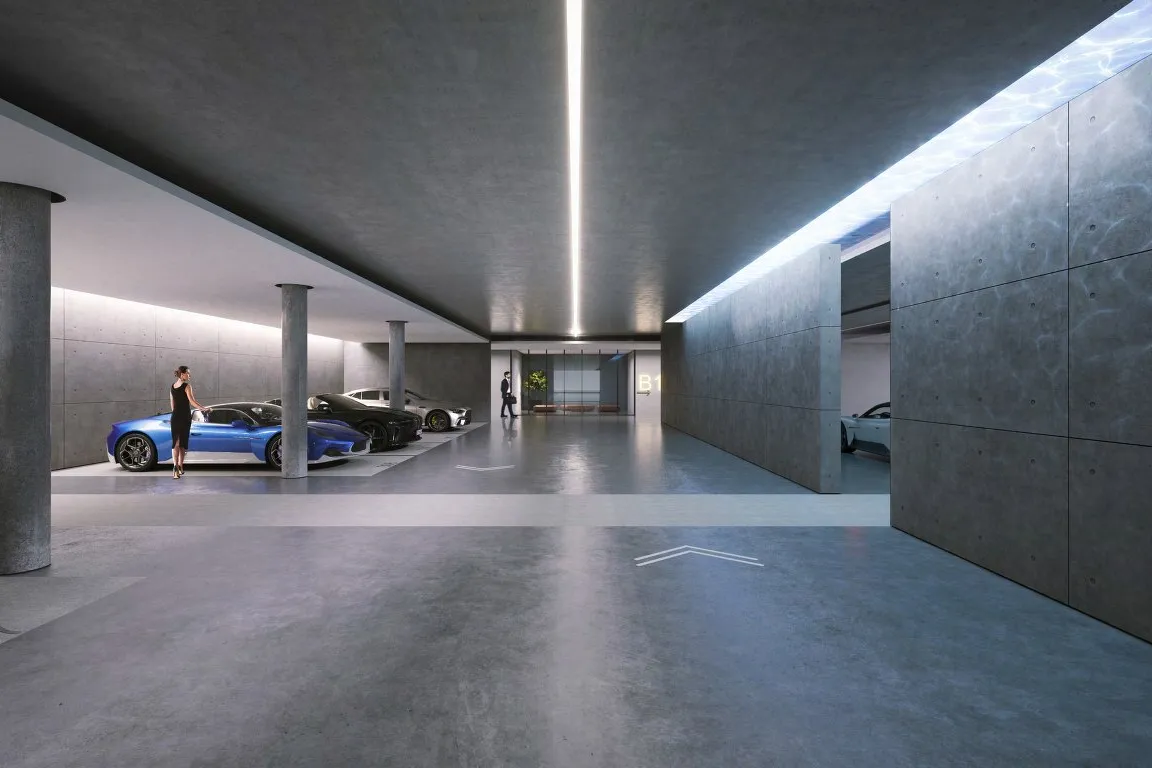Concrete residents' car park with lit ceiling slot and glowing water skylight