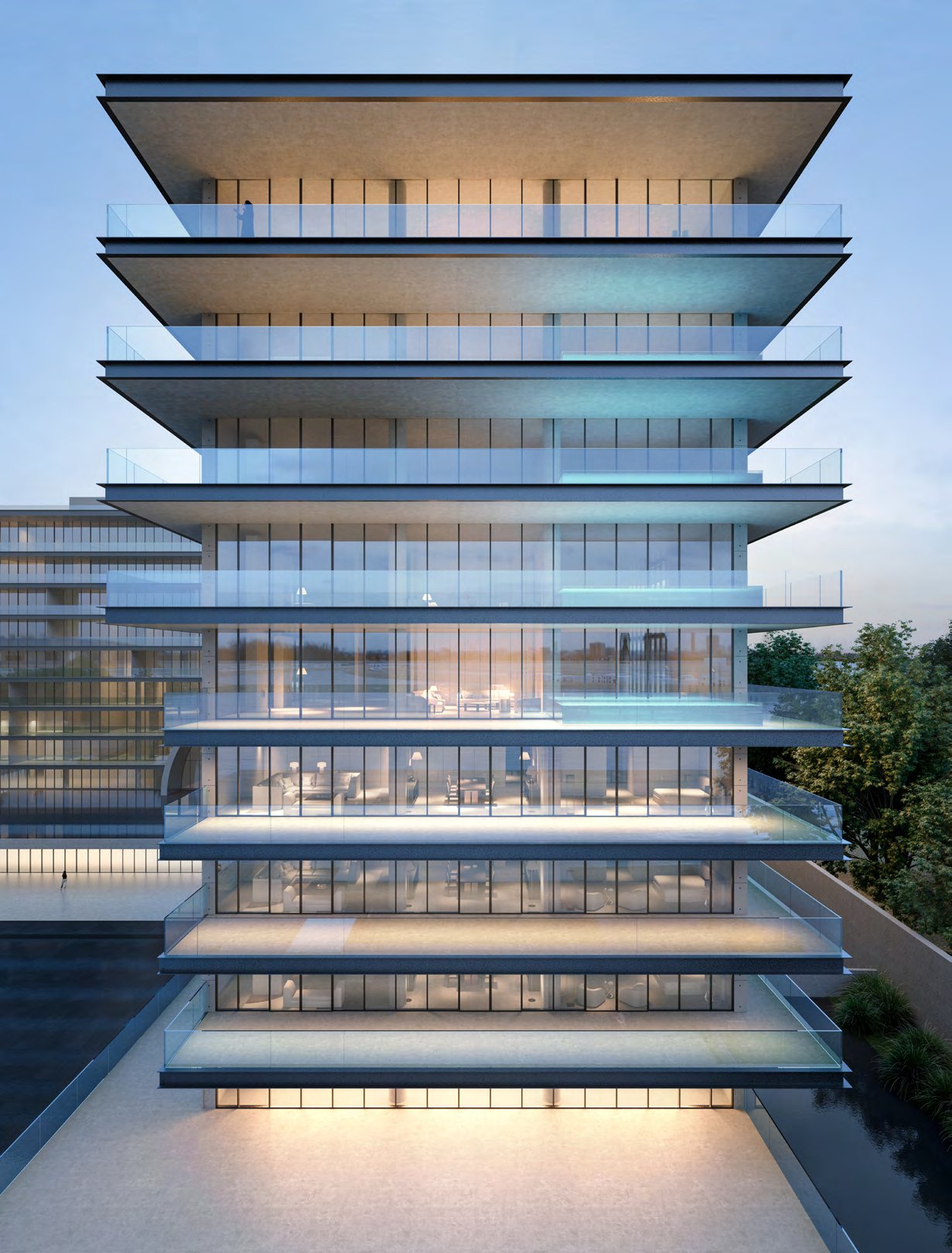 Glass-fronted wing with deep cantilevered terraces glowing at twilight