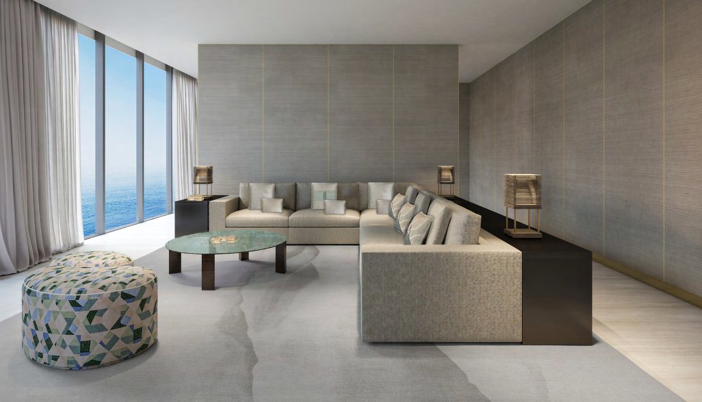 Living room with corner sofa, silk-panelled walls and tall sea-view windows