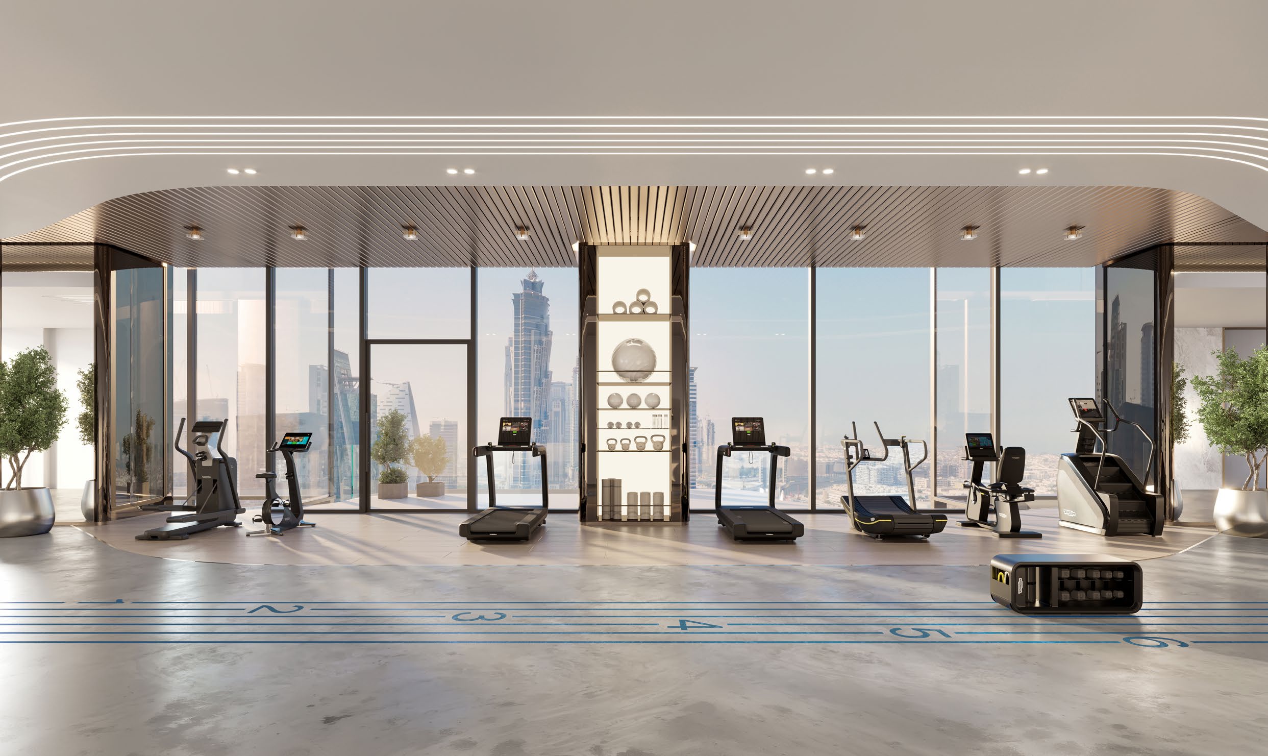 Fitness studio with treadmills and machines before full-height windows