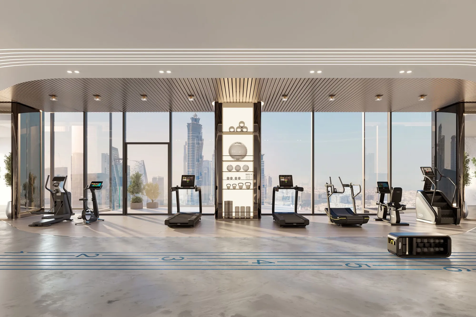 Fitness studio with treadmills and machines before full-height windows