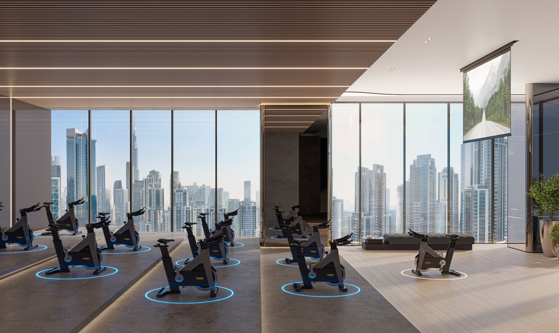 Spinning bikes facing floor-to-ceiling windows over the Downtown skyline