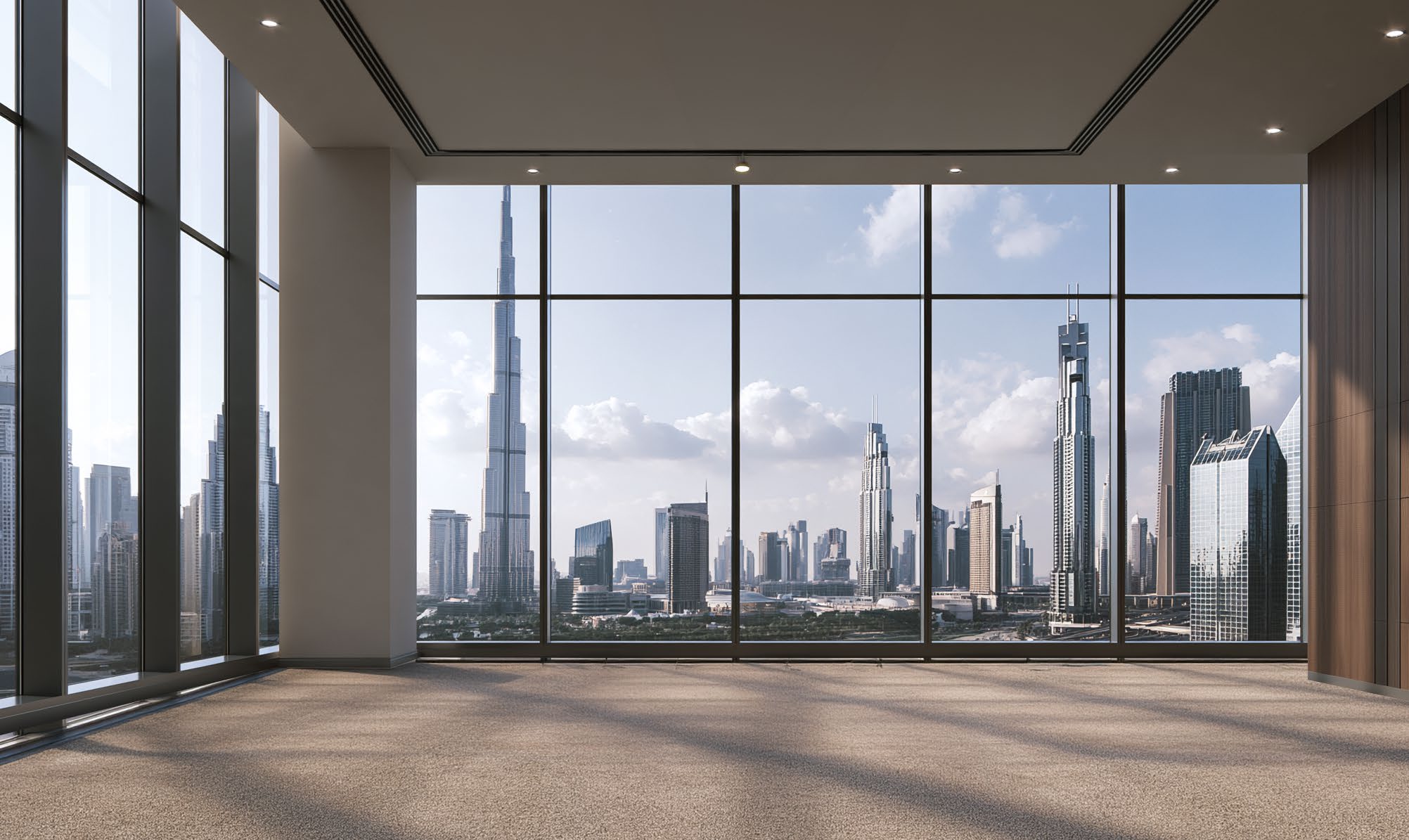 Carpeted prayer room with tall windows framing Burj Khalifa