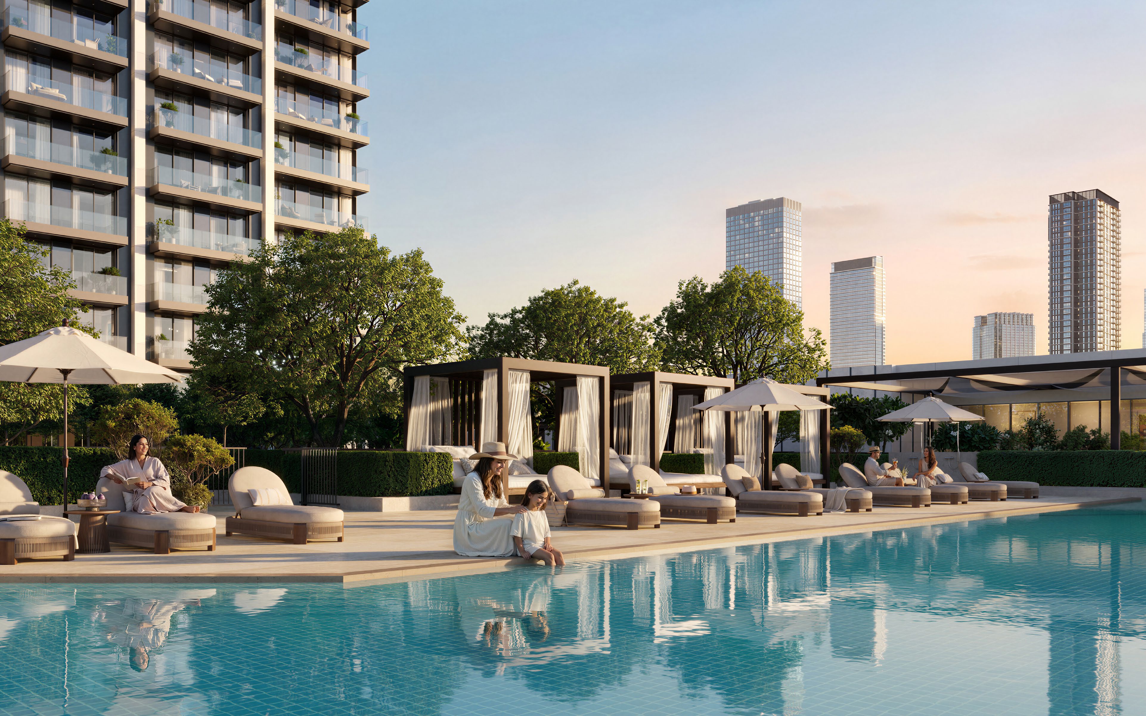Pool with loungers and curtained cabanas below Valia's balconies at sunset
