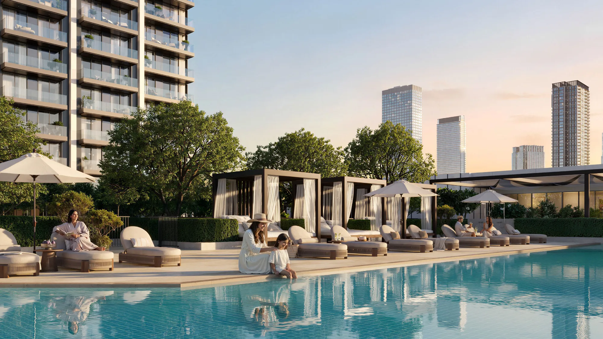 Pool with loungers and curtained cabanas below Valia's balconies at sunset