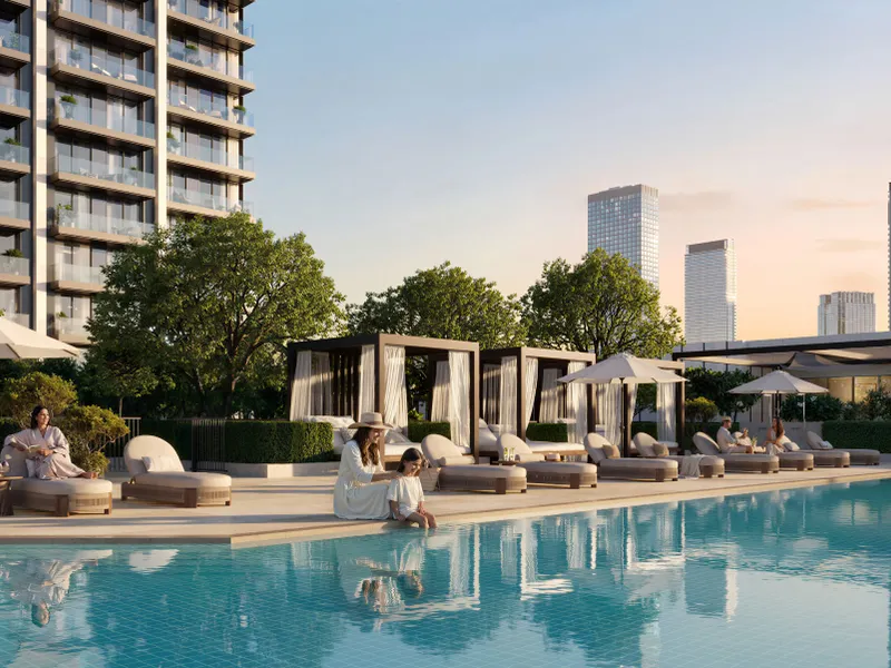 Pool with loungers and curtained cabanas below Valia's balconies at sunset