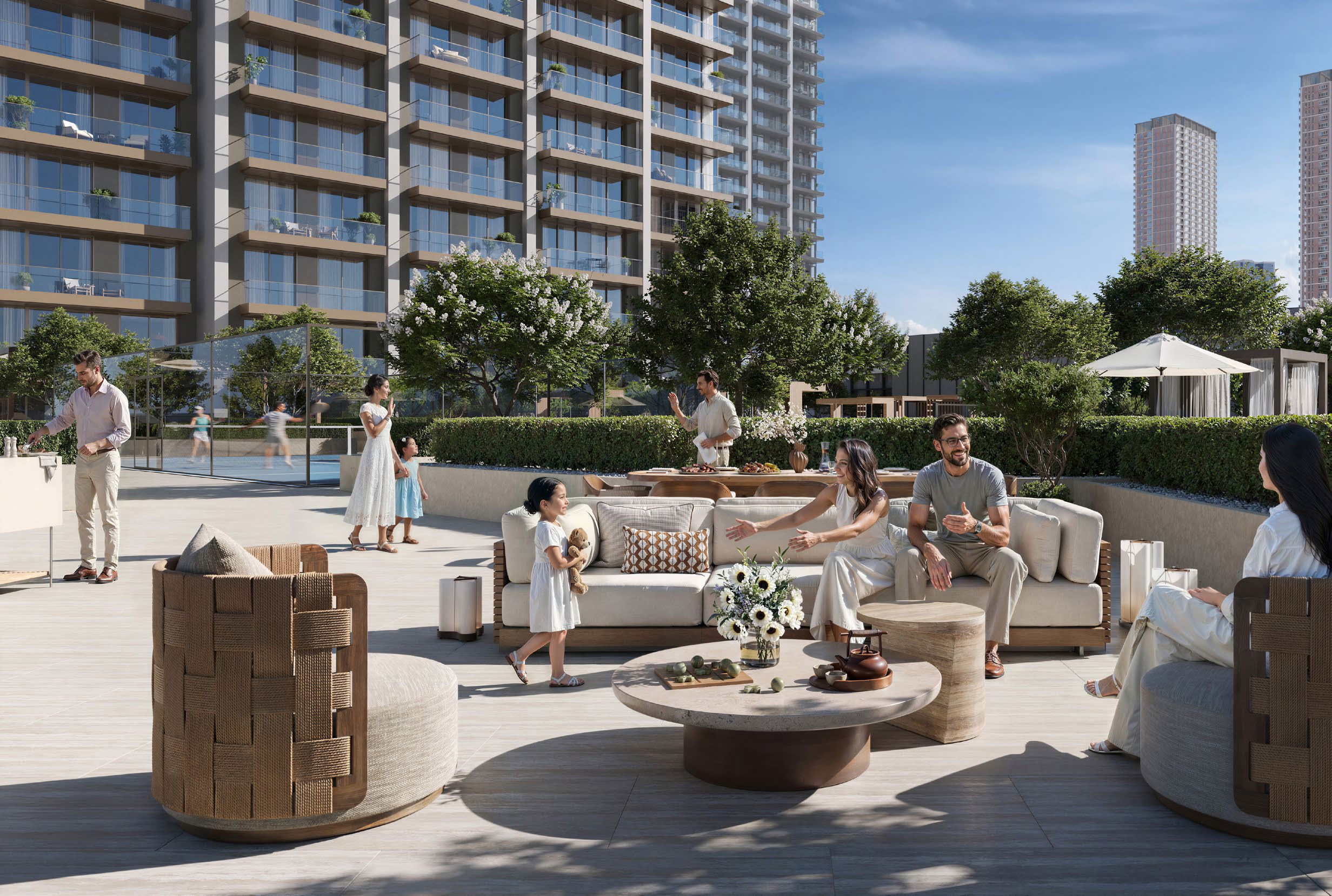 Families relaxing on woven chairs and sofas on a landscaped podium terrace