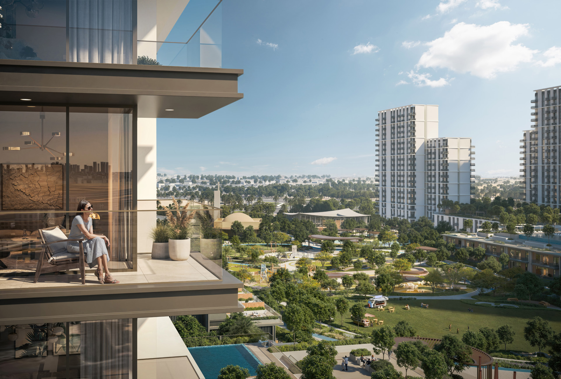 Woman relaxing on a balcony overlooking parkland and nearby towers