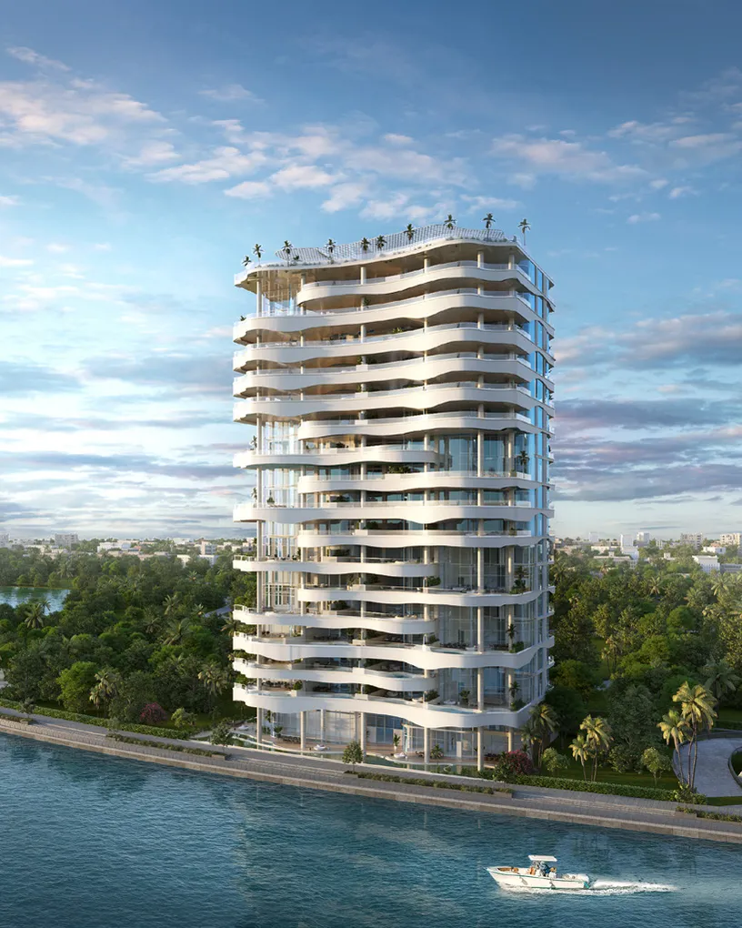 White tower with wave-shaped balconies on the canal bank beside green parkland