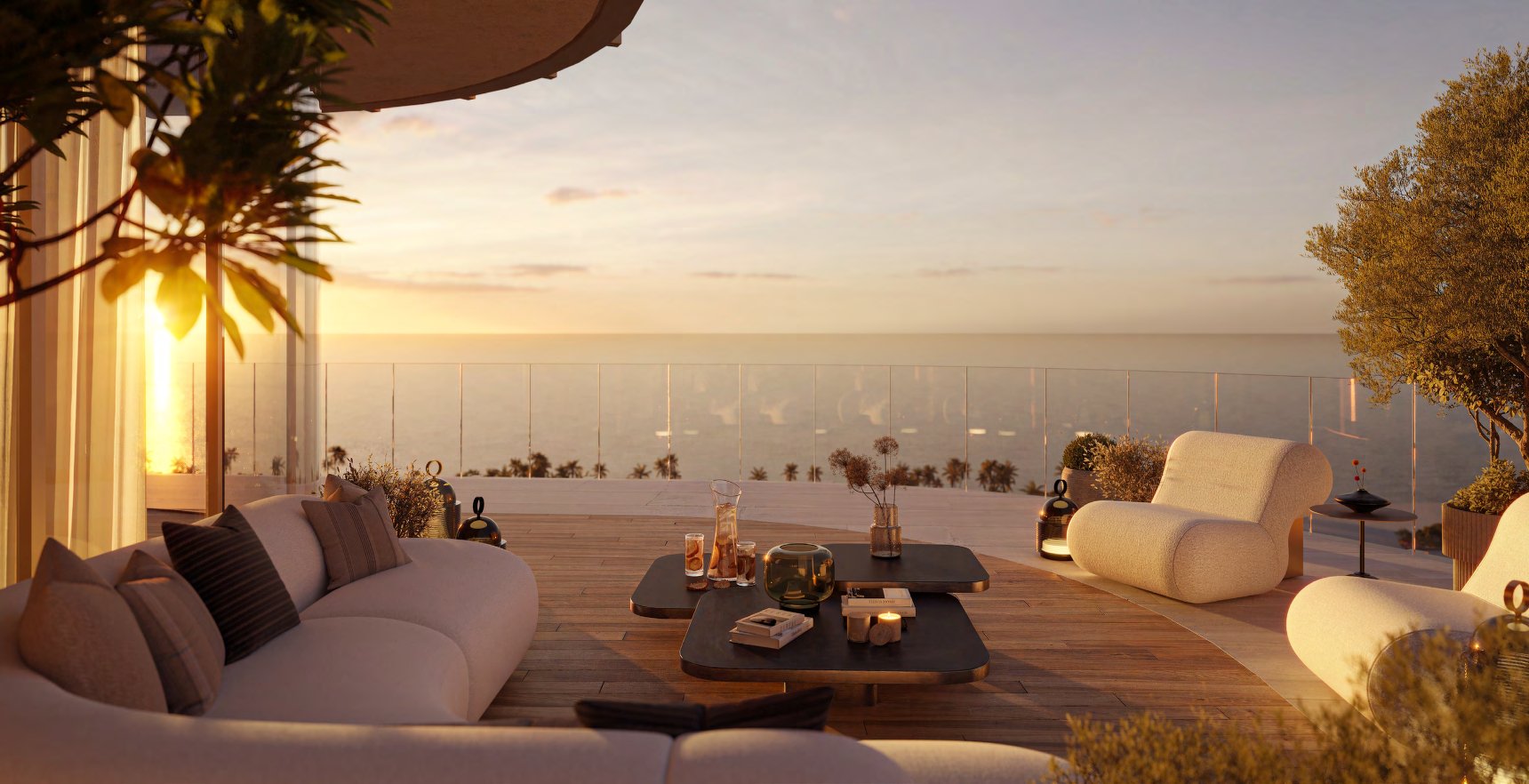 Private terrace with soft seating overlooking the sea at sunset