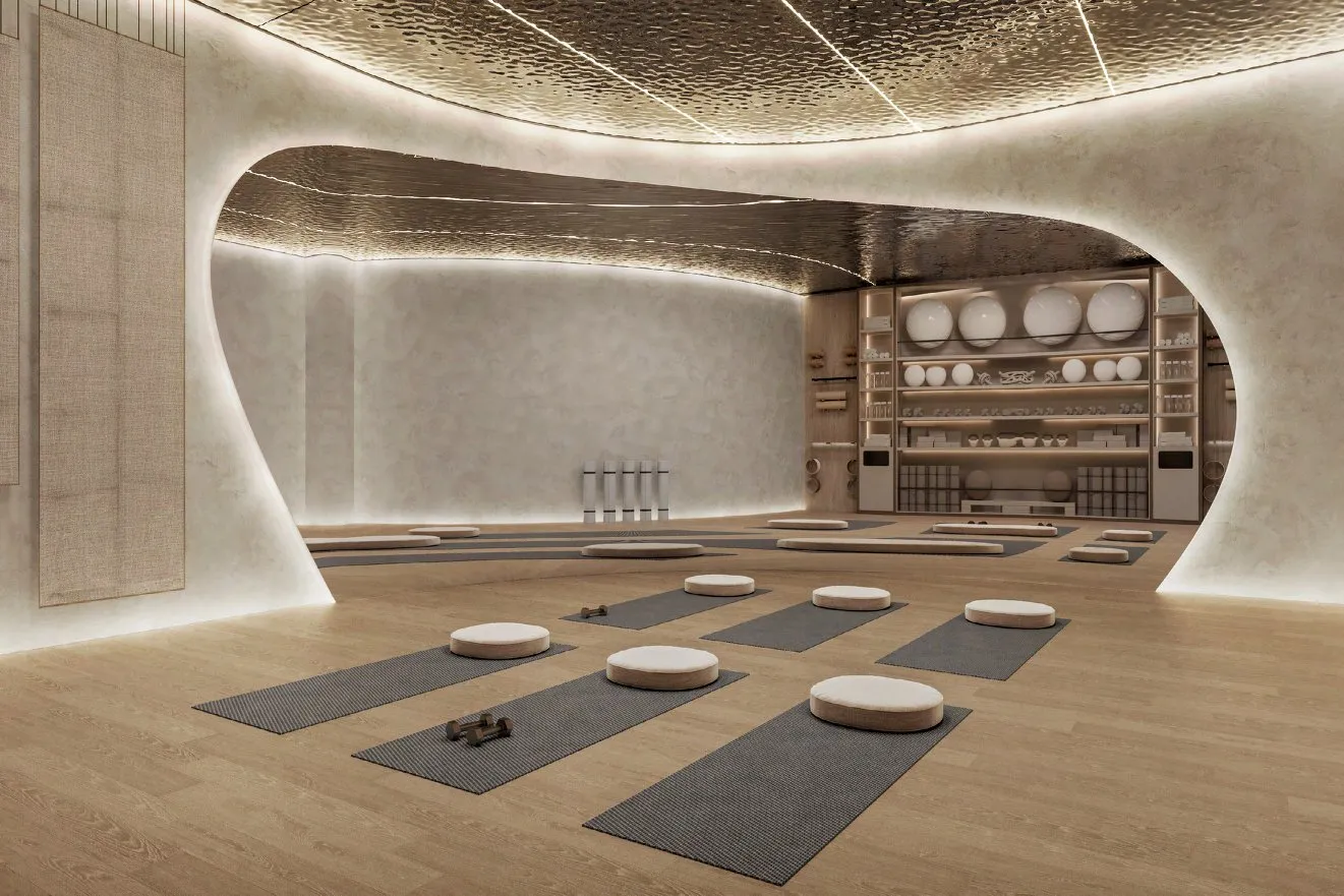 Yoga studio with oak floor, mats and softly lit curved walls