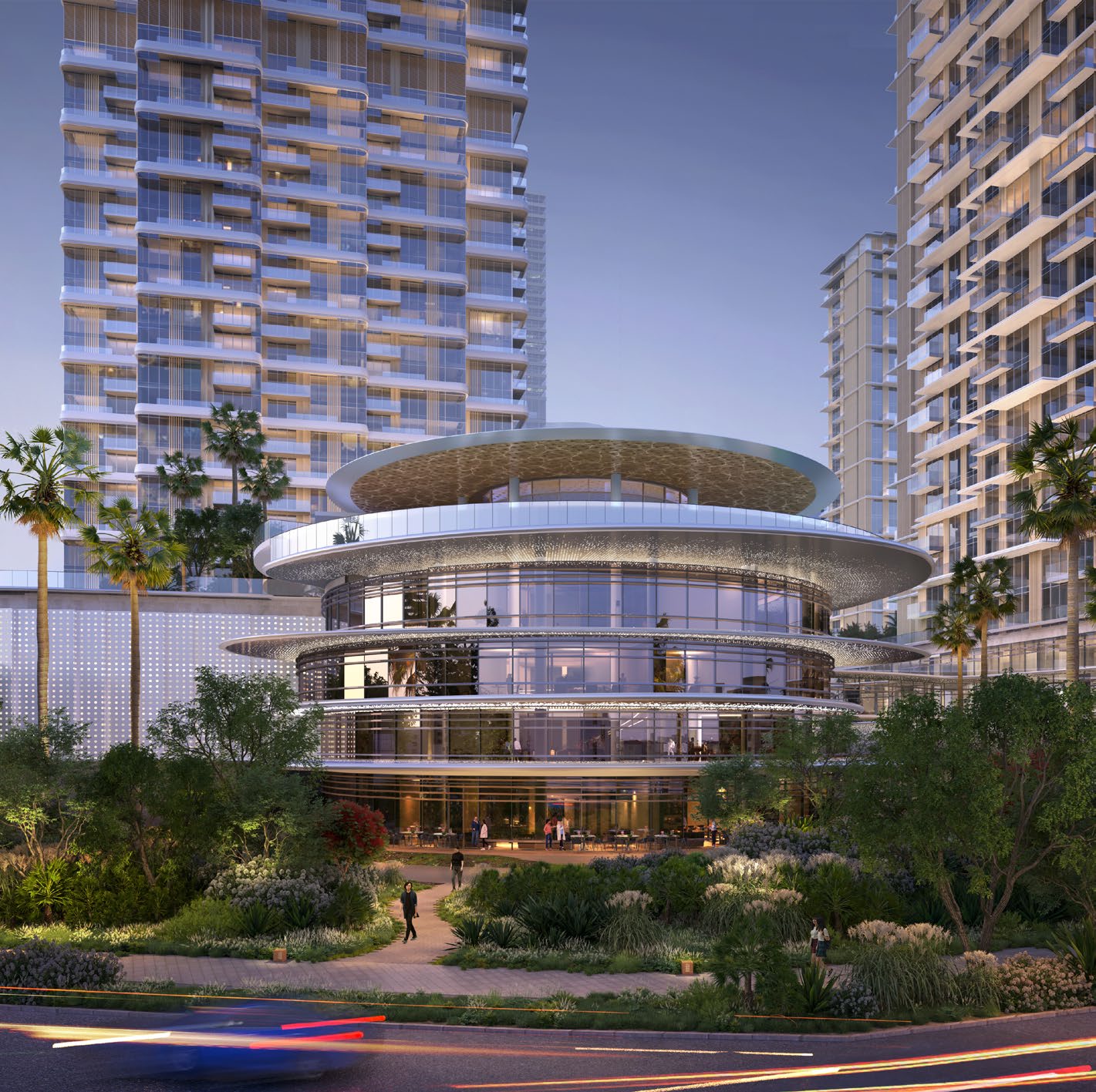Circular glass clubhouse among gardens with towers behind at dusk