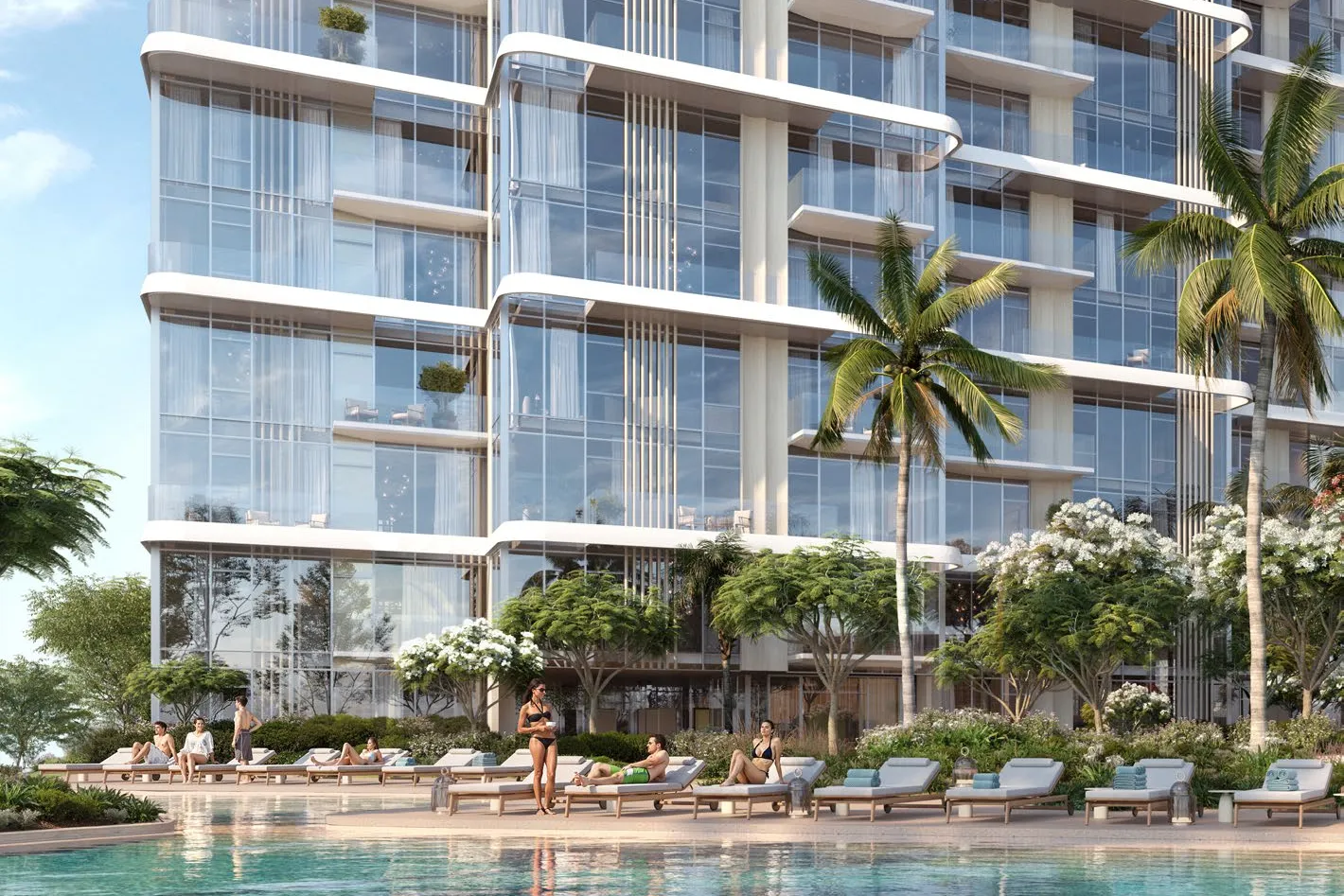 Pool with sun loungers and palms at the foot of a tower