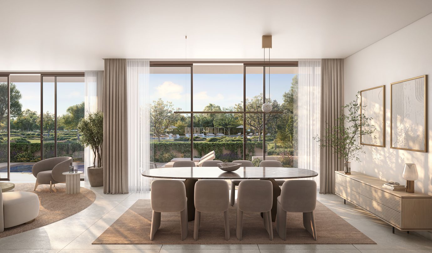 Dining table set before full-height windows facing greenery