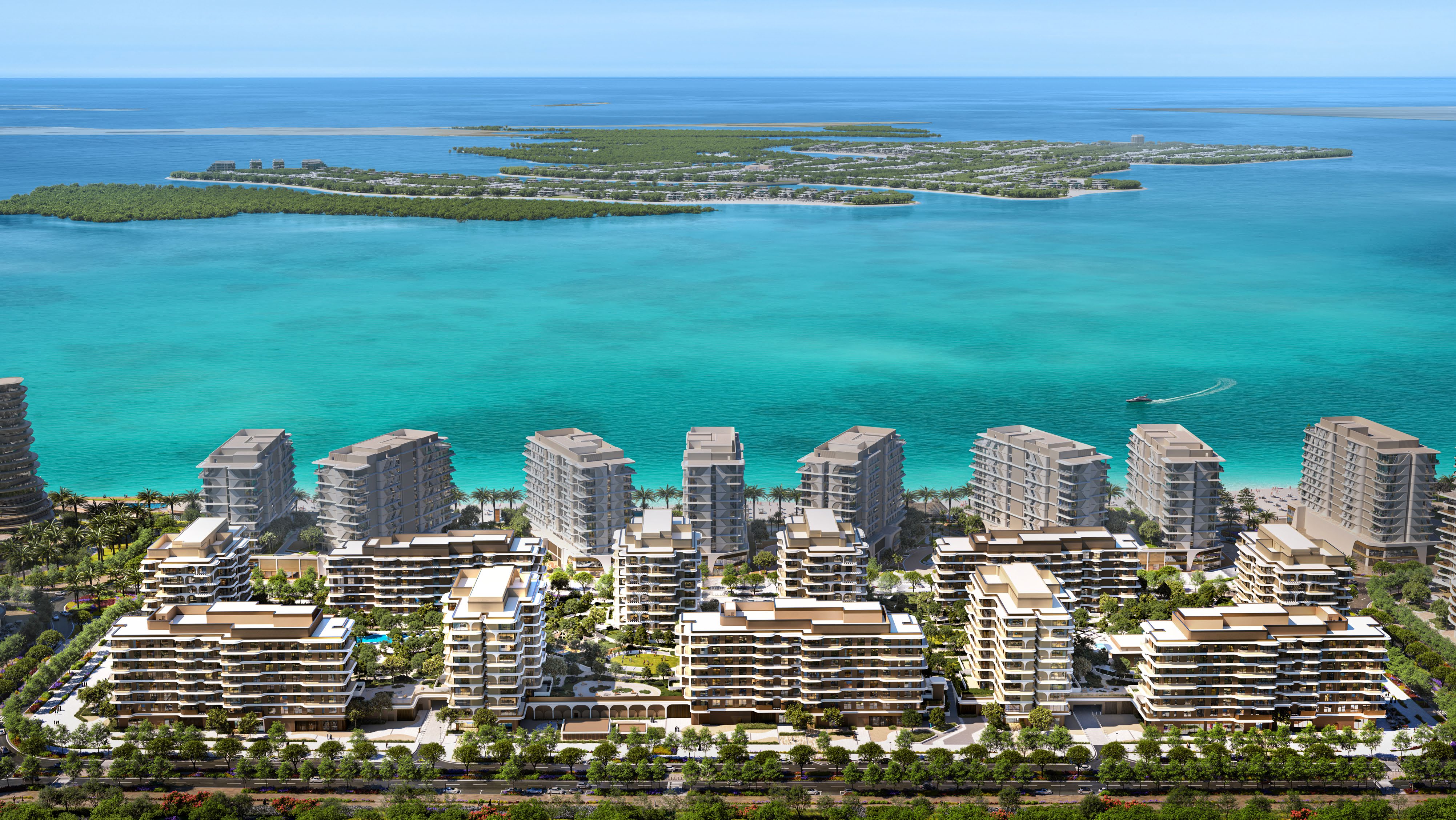 Aerial view of the Beach House towers and gardens beside a turquoise sea