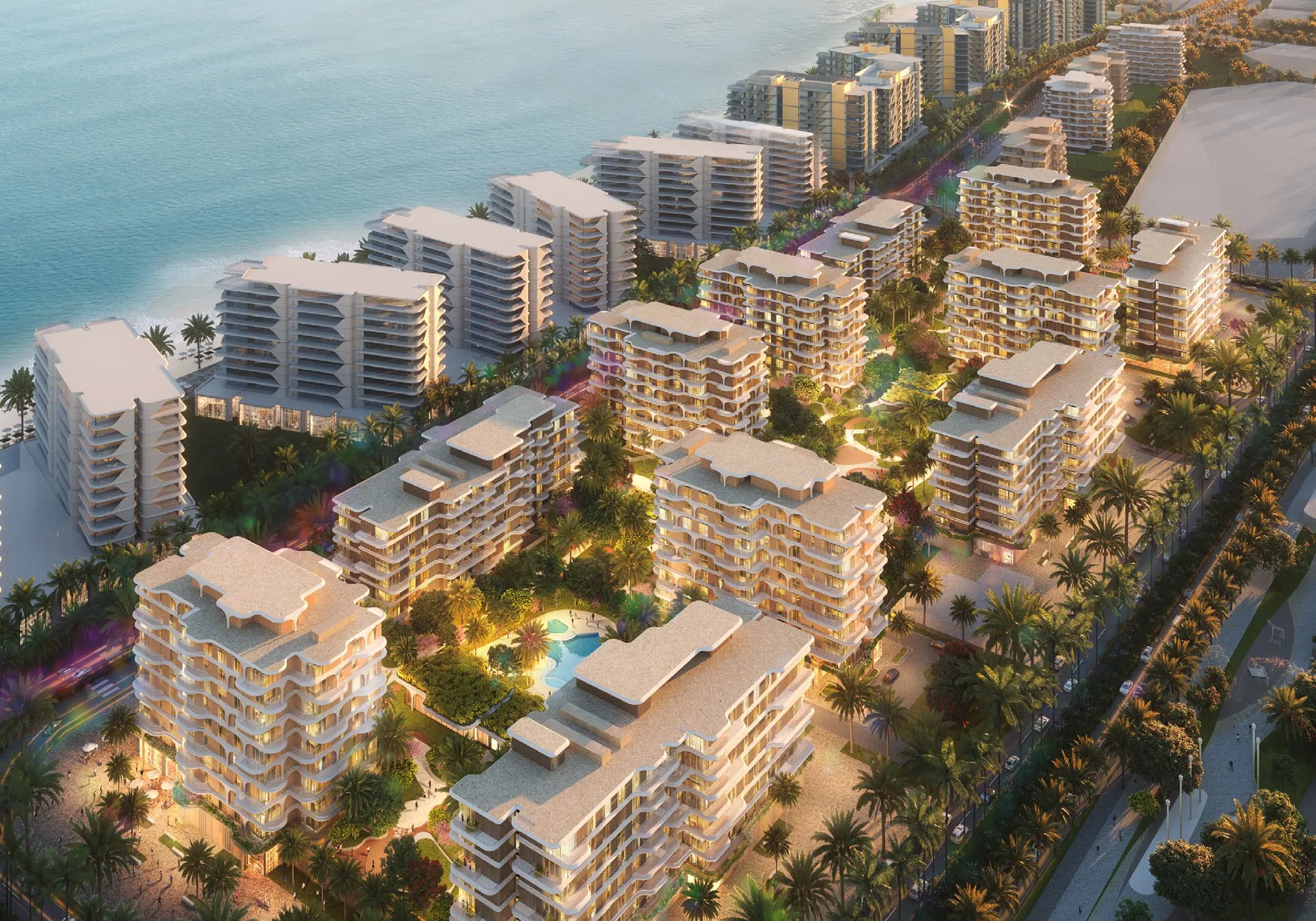 Evening aerial of the towers and palm-lined streets along the Fahid Island coast