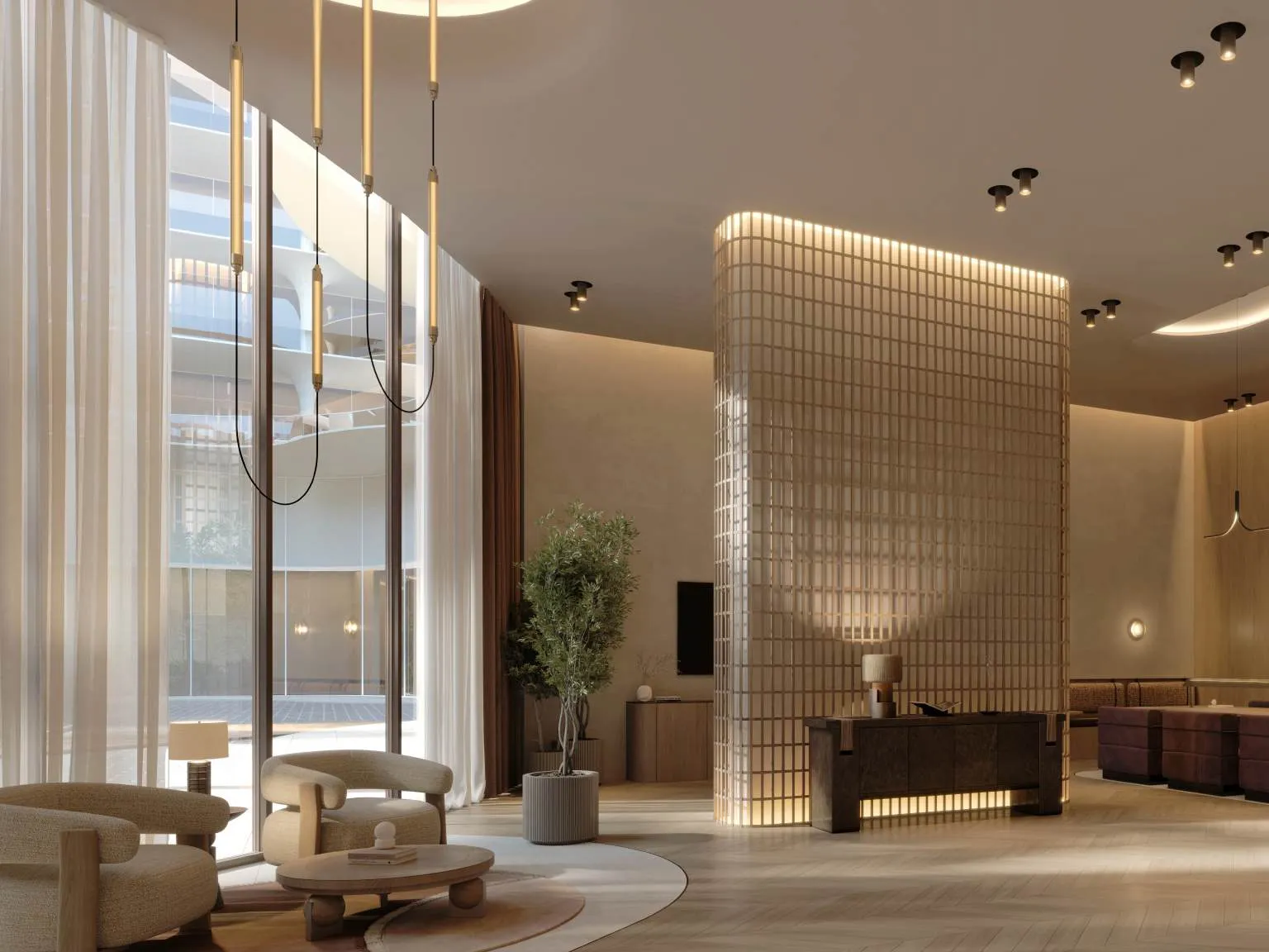 Bright lobby with tall windows, glass-block reception and soft armchairs