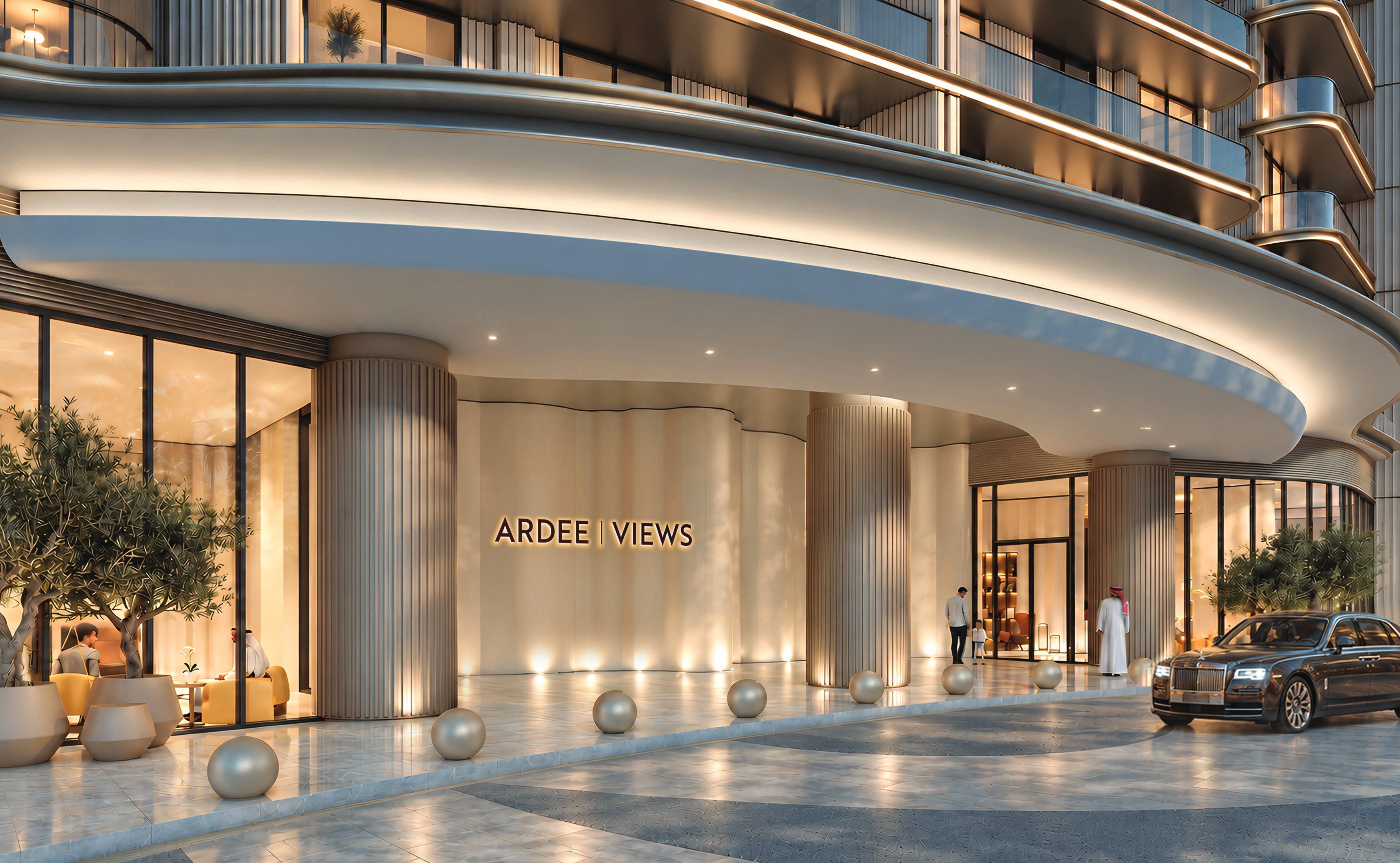 Curved, softly lit entrance canopy of Ardee Views with a car at the door
