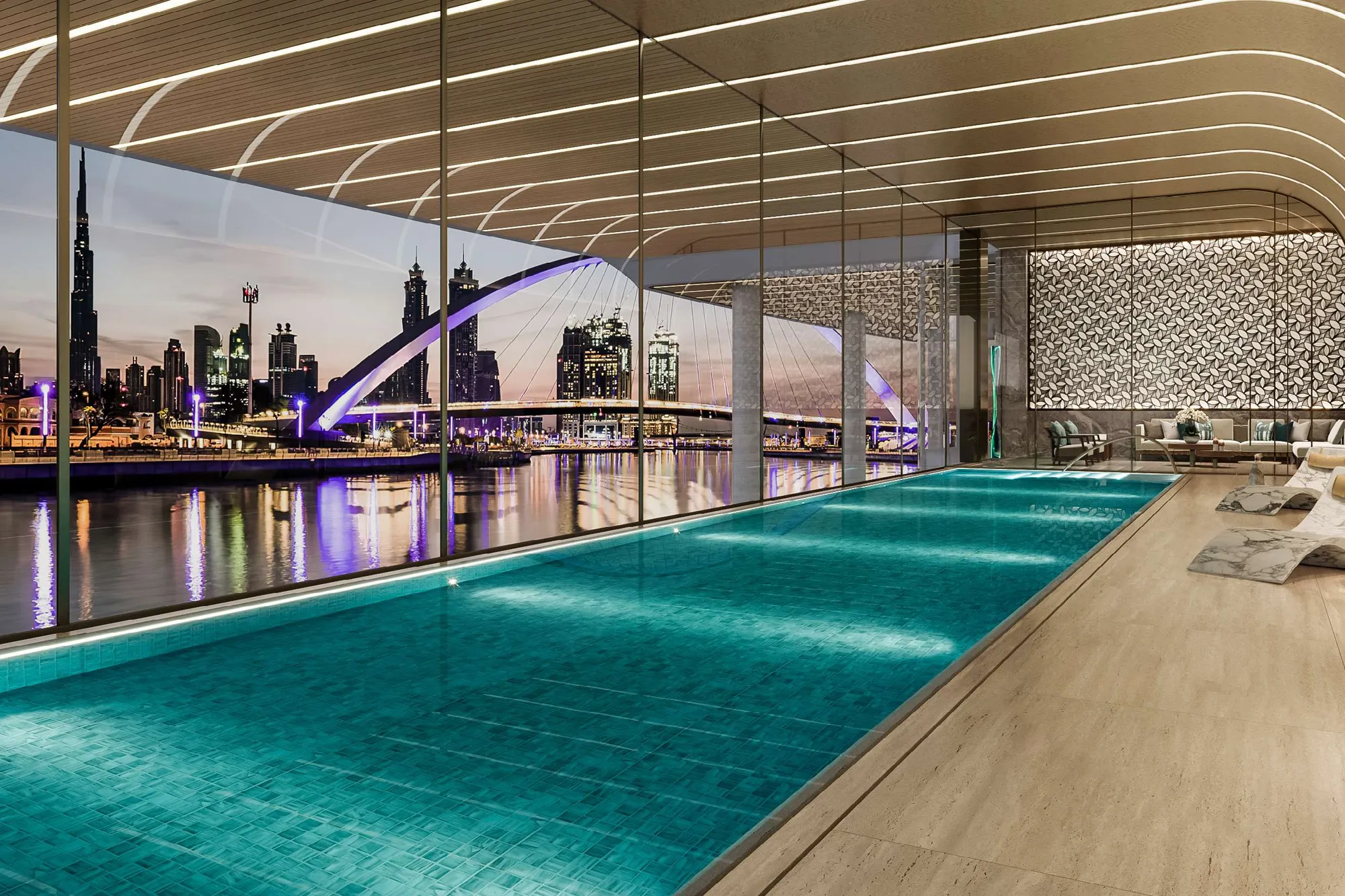 Indoor pool behind tall glass looking over the canal at dusk
