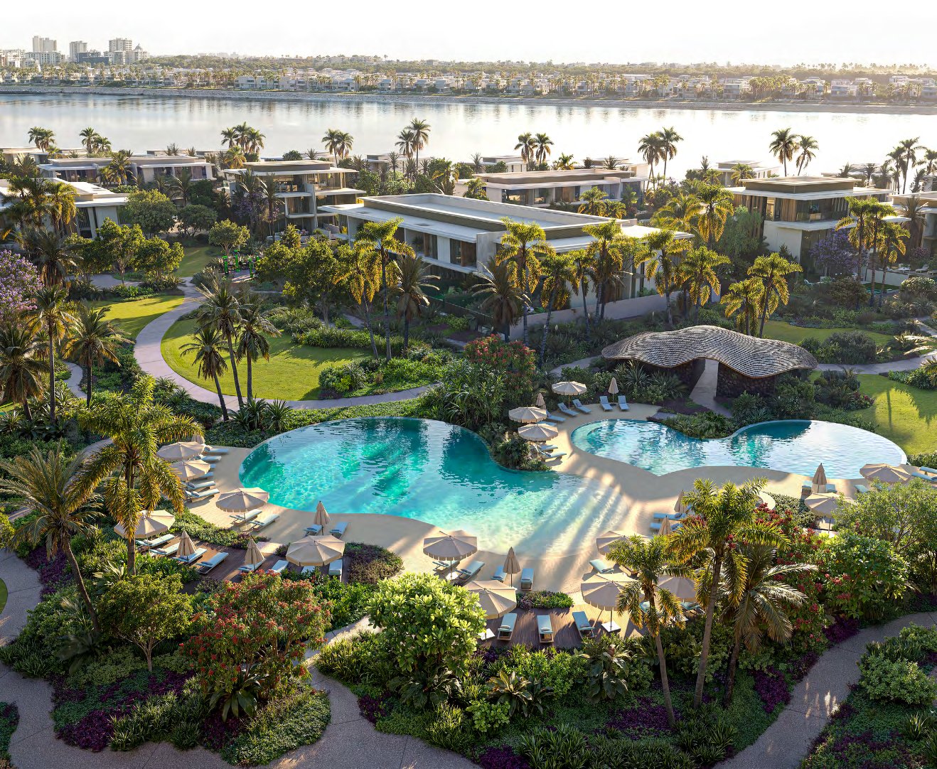 Pool clubhouse with curved pools, parasols and gardens beside the water