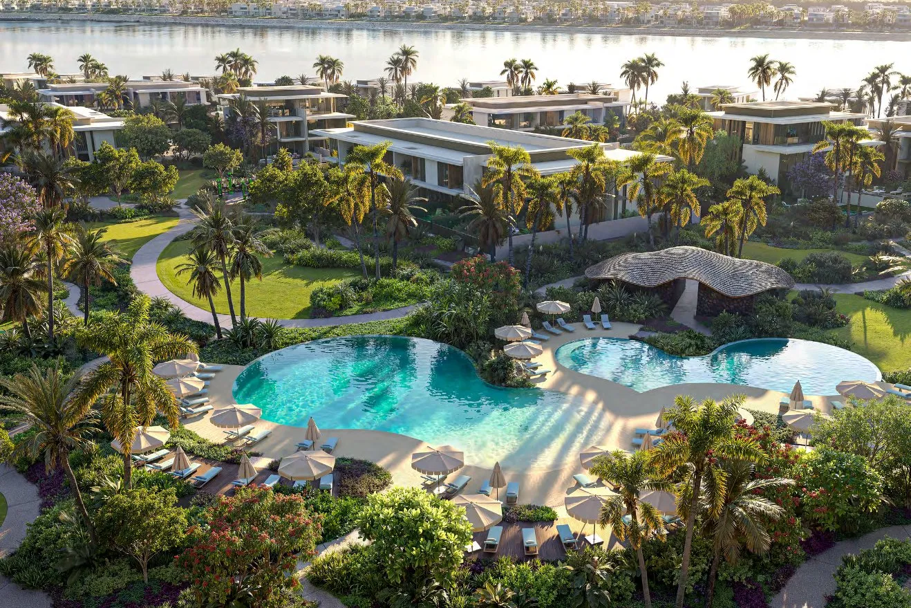 Pool clubhouse with curved pools, parasols and gardens beside the water