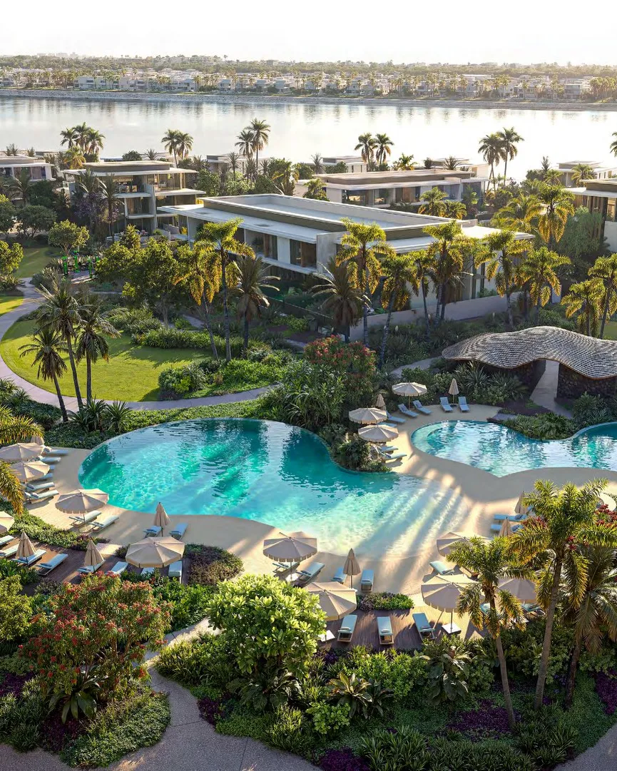 Pool clubhouse with curved pools, parasols and gardens beside the water