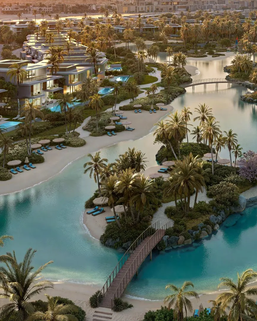 Lagoon at dusk with yoga deck, footbridges and lit villas behind