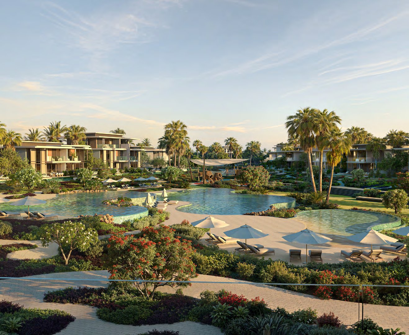 Shared pools with parasols and flowering gardens between the villas