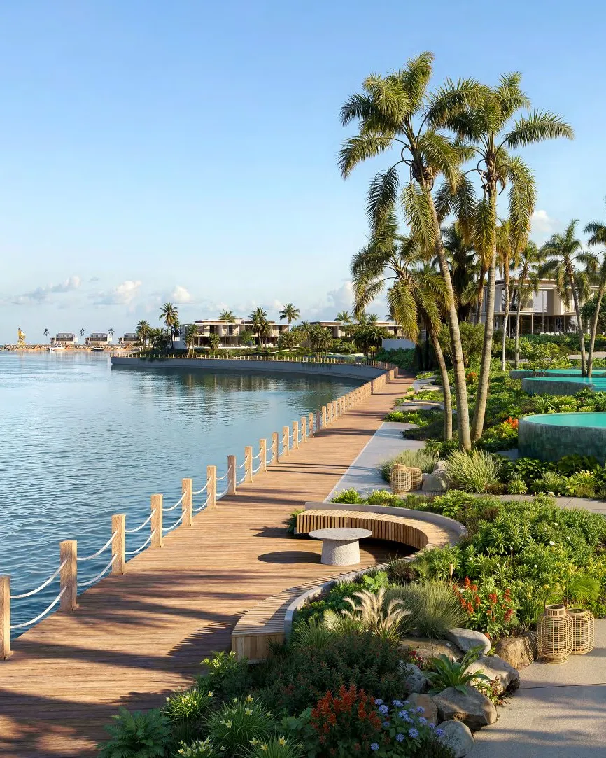 Timber promenade along the water with palms and villas beside it