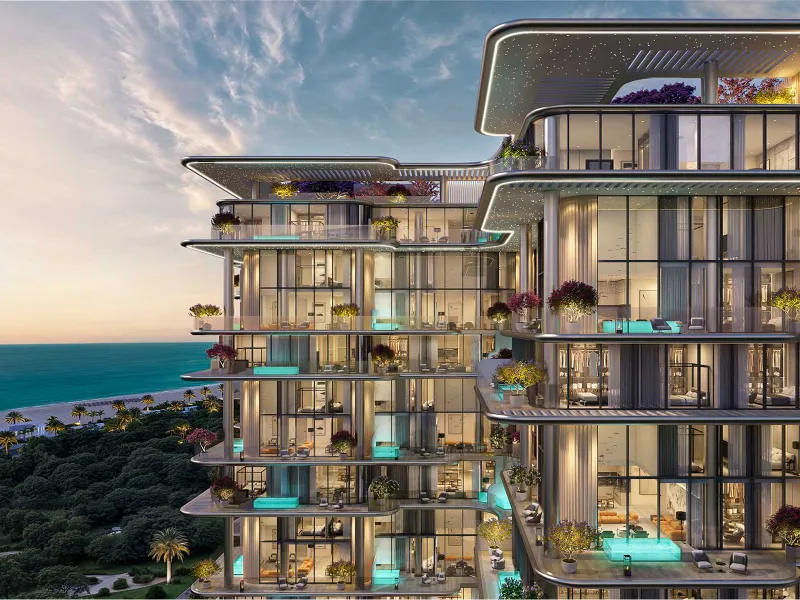 Villa del GAVI's glass facade and planted terraces above the beach at sunset