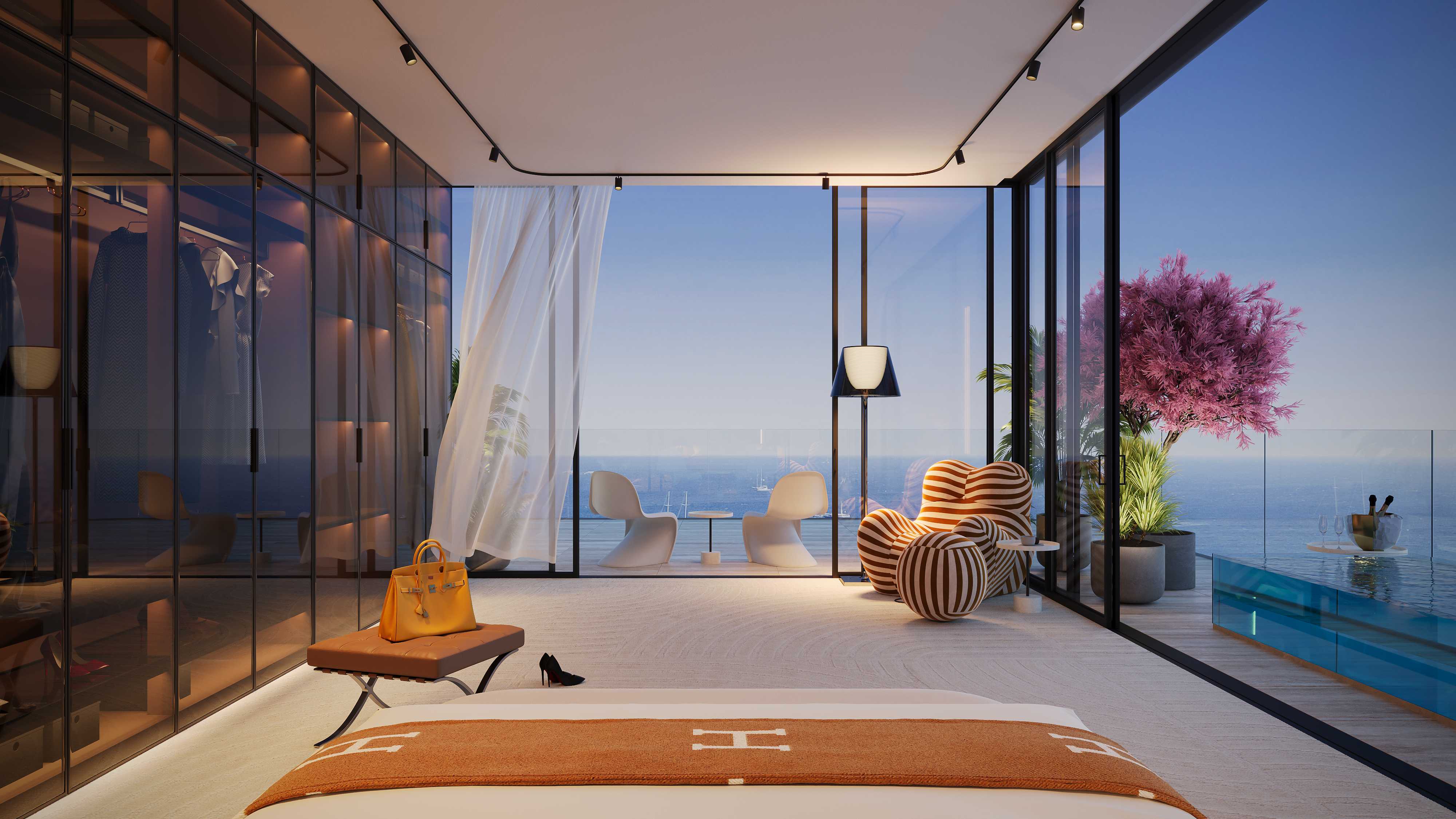 Bedroom with glass wall opening onto a terrace pool and the sea