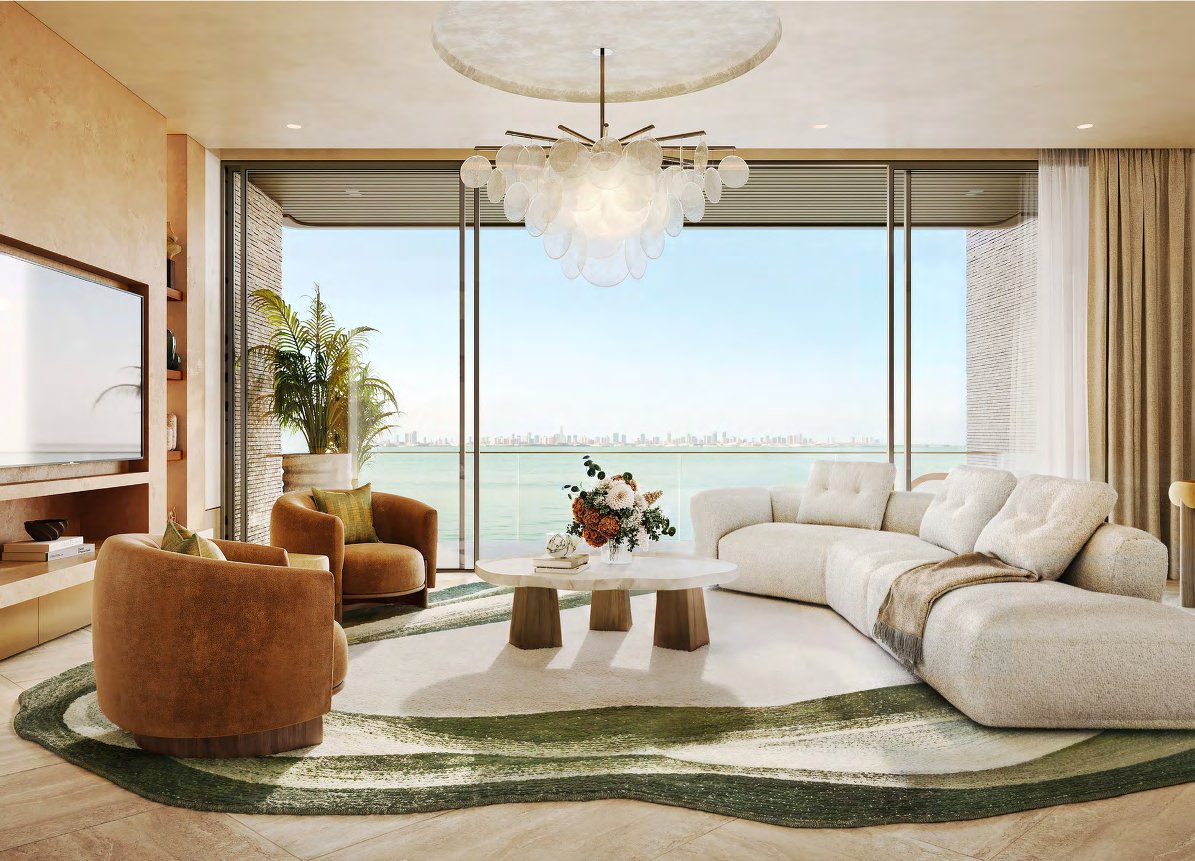 Living room with curved sofa and floor-to-ceiling windows onto the sea