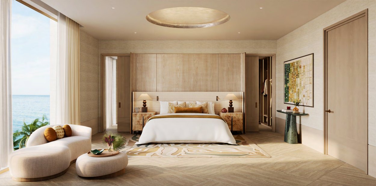 Main bedroom in warm timber tones with a window onto the sea