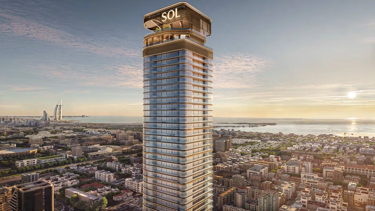 Sol Luxe tower at sunset above the city, with the sea and Burj Al Arab