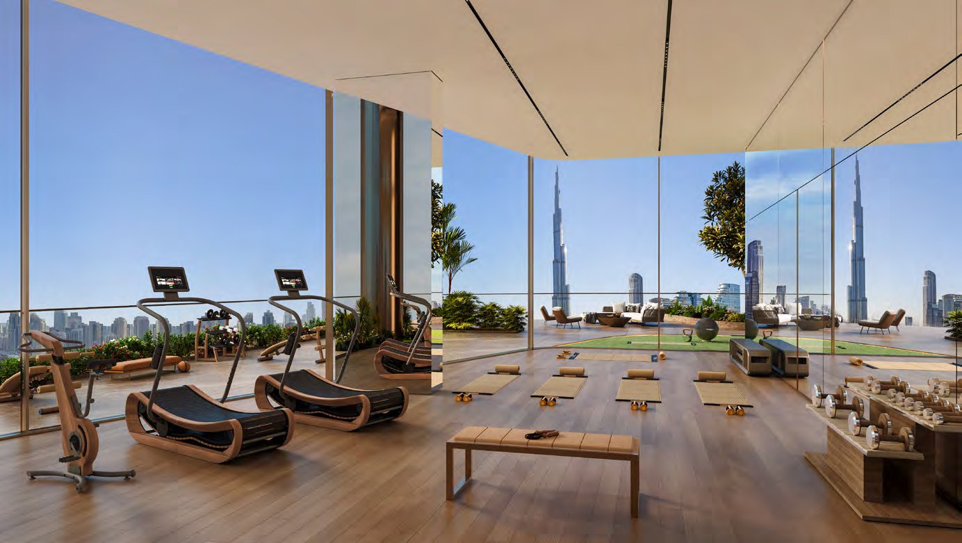 Glass-walled gym with treadmills and yoga mats overlooking the skyline