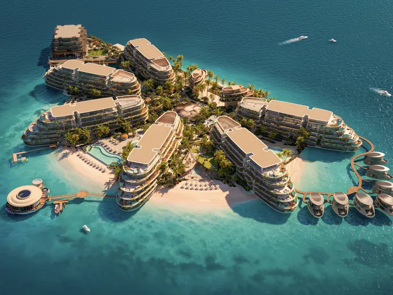 Aerial of the whole island with buildings, beaches and over-water villas