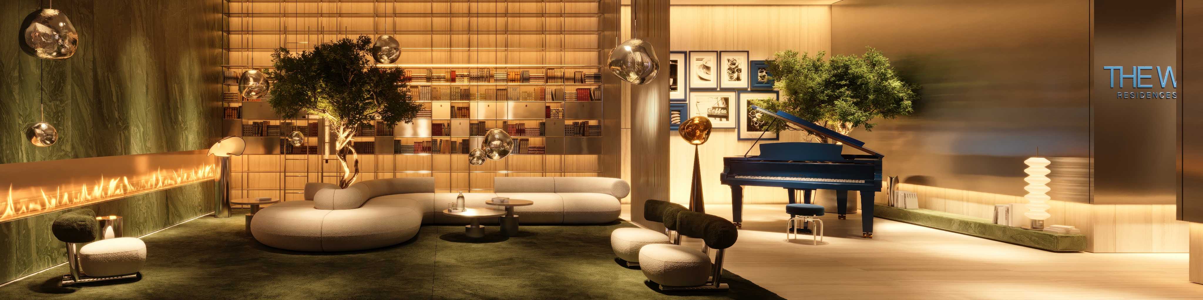 Lobby lounge with curved sofa, library shelves and blue grand piano