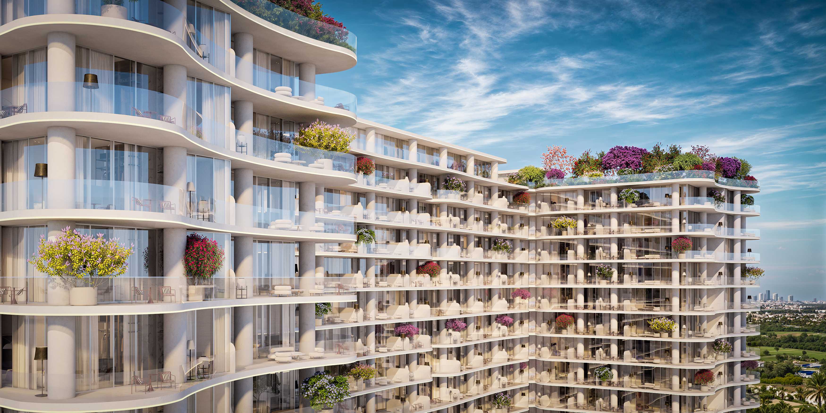 White tower facade with curving balconies and flowering planters