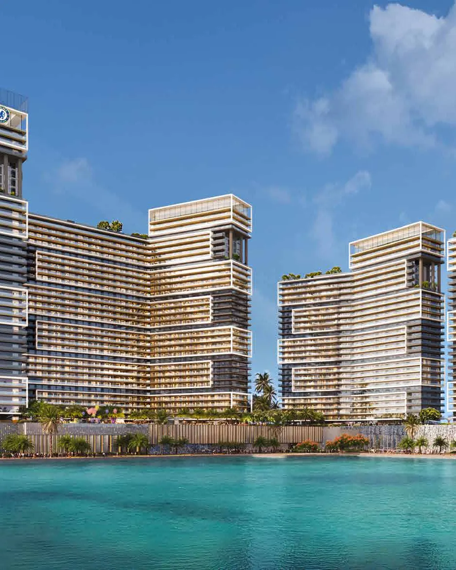 Chelsea Residences towers rising above palm trees and turquoise water